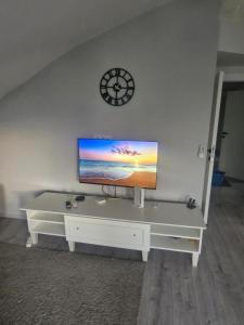 a living room with a flat screen tv on a wall at Apartment close to the sea in the most central of city in Antalya