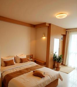 a hotel room with two beds and a window at STERLEON HOTEL RIVERSIDE in Nairobi