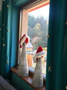 two santa hats sitting on a window sill at Villa Eva & Lilou Pod Rysianką in Żabnica +39 photos