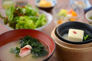 a bowl of soup with broccoli and cheese and a salad at ニッポニア高原宿夢海月-ゆめみづき- in Ito
