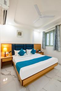 Un dormitorio con una cama grande con almohadas azules. en Hotel New King Castle International- Free Airport Pick up, en Nueva Delhi
