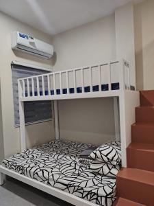 a small bedroom with a bunk bed with at three x apartelle in Tagbilaran City
