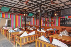 a dining room with wooden tables and chairs at Sea Star Resort in Agonda