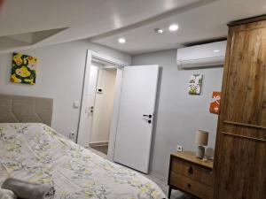 a bedroom with a bed and a wooden cabinet at Apartment close to the sea in the most central of city in Antalya