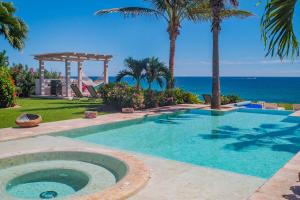 a swimming pool with a gazebo and the ocean at Casa Piedra Blanca in San José del Cabo
