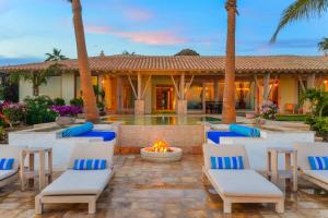 a patio with chairs and a fire pit in front of a house at Casa Piedra Blanca in San José del Cabo +25 photos