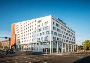 a white building on the corner of a street at Me and All Hotel Berlin East Side, by Hyatt - NEW OPENING in Berlin