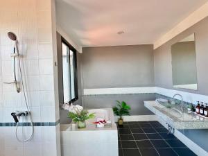 a bathroom with a shower and a tub and a sink at Serenity by Peace Garden in Amphoe Koh Samui +29 photos
