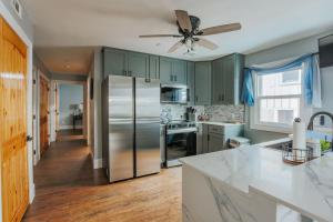 a kitchen with green cabinets and a stainless steel refrigerator at Fishersville Oasis in Fishersville