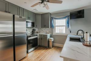 a kitchen with stainless steel appliances and a ceiling fan at Fishersville Oasis in Fishersville