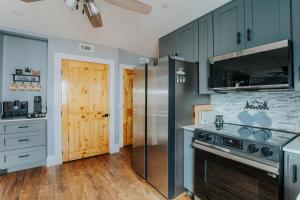 a kitchen with blue cabinets and a stove at Fishersville Oasis in Fishersville +5 photos