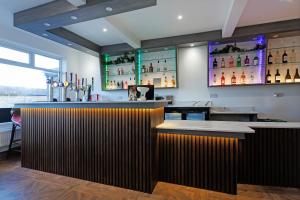 a bar in a restaurant with a dark wooden counter at Savoy 5 in Ayr