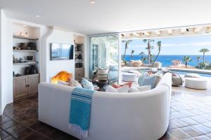 a living room with a white couch and a fireplace at Casa Sirena in San José del Cabo