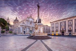 a building with a fountain in front of a building at Garibaldi guest house in Catania