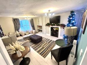 a living room with a christmas tree and a couch at Hexham Town Centre, Market Place View in Hexham
