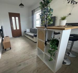 a living room with a desk with plants on it at Studio Cosy avec déco artisanale unique in Voeuil-et-Giget +3 photos