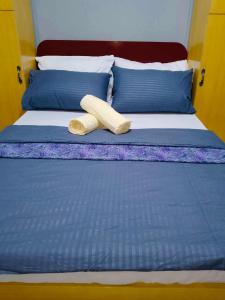 a bed with two pillows on it with at Z House of Guests 6- Mambago B, Samal Davao Del Norte in Samal