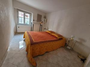 a bedroom with a bed in a room with a window at Sanceflo in Mandelieu-La Napoule