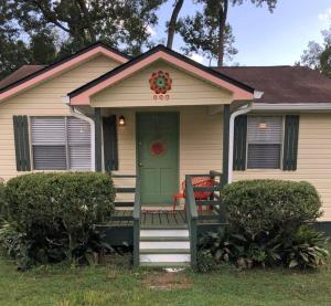a house with a green door and a porch at Quiet-Clean-Cottage-Dogs Kitchen in Tallahassee
