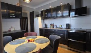a kitchen with a table with fruit on it at White House Apartment in Jūrmala +7 photos
