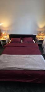 a bedroom with a large bed with two night stands at White House Apartment in Jūrmala