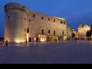 a large castle with a person standing in front of it at Thysia in Conversano