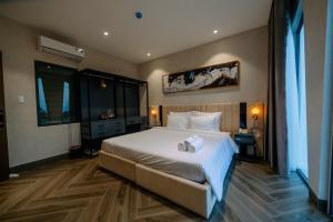 Кровать или кровати в номере La Beaute Hotel - Quy Nhơn