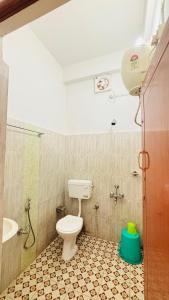 a bathroom with a toilet and a shower and a sink at Toncheng Homestay in Kāziranga