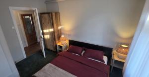 a bedroom with a bed and two lamps on two tables at White House Apartment in Jūrmala