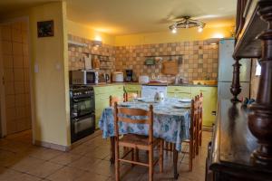 a kitchen with a table with a blue table cloth on it at LE MYRO in Péreyres