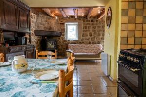a kitchen with a table and a counter top at LE MYRO in Péreyres