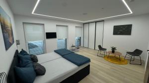 a bedroom with a bed and a table and chairs at Apartmany ZAHRADNICKA in Myjava