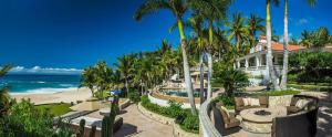 a house on the beach with palm trees and the ocean at Casa Edwards in San José del Cabo