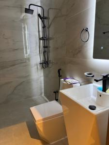 a bathroom with a white sink and a shower at سكينة هاوس in Riyadh +19 photos