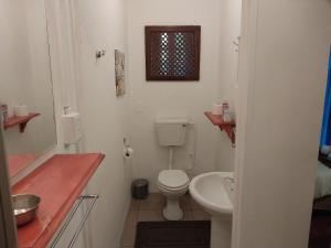 a small bathroom with a toilet and a sink at Lily Guesthouse in Bloemfontein +23 photos