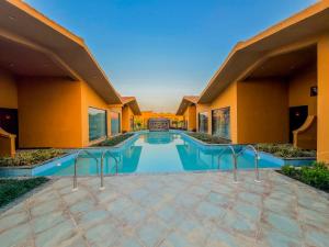 a swimming pool in the middle of a building at Spree Resort Jim Corbett in Belparāo