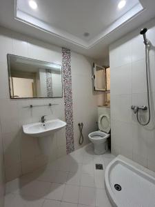 a bathroom with a sink and a toilet and a mirror at Studio à louer - Kélibia centre ville in Kelibia