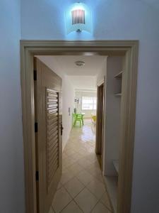 a hallway with a blue light on the ceiling at Studio à louer - Kélibia centre ville in Kelibia