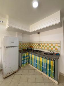 a kitchen with a sink and a refrigerator at Studio à louer - Kélibia centre ville in Kelibia
