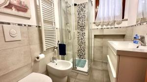 a bathroom with a toilet and a sink and a shower at Bilocale con balcone a Numana - N080 in Sirolo +7 photos