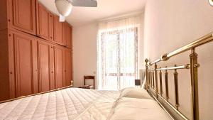 a bedroom with a bed and a large window at Bilocale con balcone a Numana - N080 in Sirolo