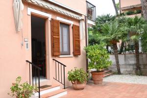 a house with potted plants in front of it at Bilocale con balcone a Numana - N080 in Sirolo