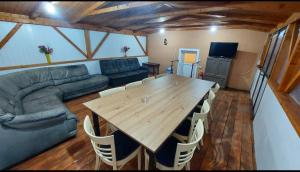 a living room with a wooden table and a couch at Cabana Lunca in Lunca Ampoiţei