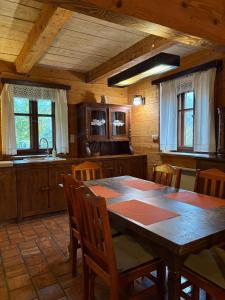 a kitchen with a table and chairs in a room at Hriady in Wetlina +19 photos