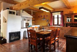 a dining room with a table and chairs in a kitchen at Hriady in Wetlina
