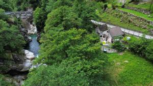 an aerial view of a river next to a bridge at Rustic on the Verzasca River in Corippo +1 photo