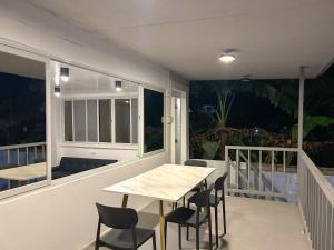 a room with a table and chairs on a balcony at EC HomeStay in Tarlac