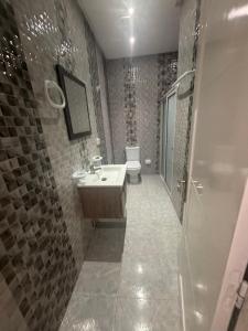 a bathroom with a sink and a toilet at Résidence Maha in Hammam Sousse