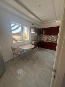 a kitchen with a table and chairs in a room at Résidence Maha in Hammam Sousse +20 photos