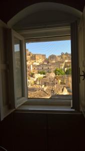 a window with a view of a city at Da Ida - Matera Cento Storico - Sassi in Matera